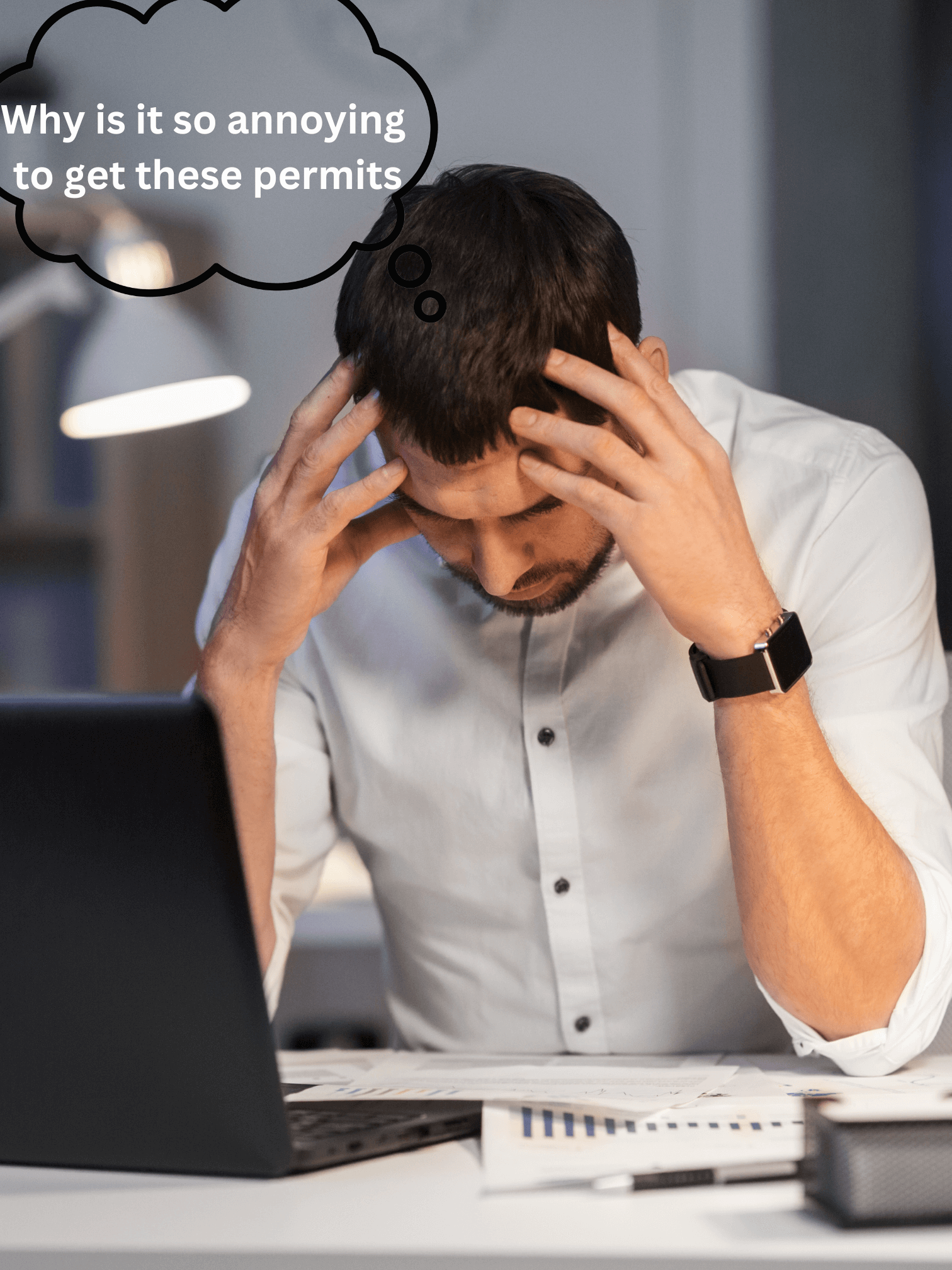 A man sitting at his desk frustrated about trying to get the right permits for his construction project.