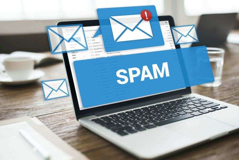 "Spam" warning displayed in an email inbox on a laptop screen
