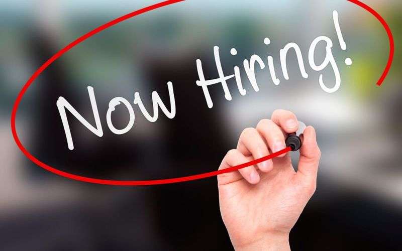 "Now Hiring!" handwritten sign circled in red marker