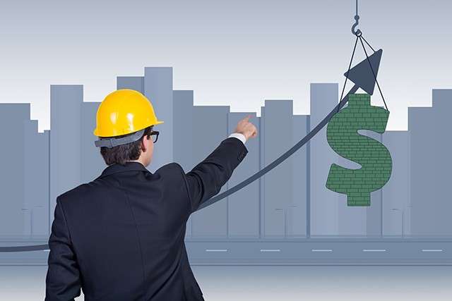 Businessman in a hard hat pointing at a rising dollar-sign graphic on a construction-themed growth chart