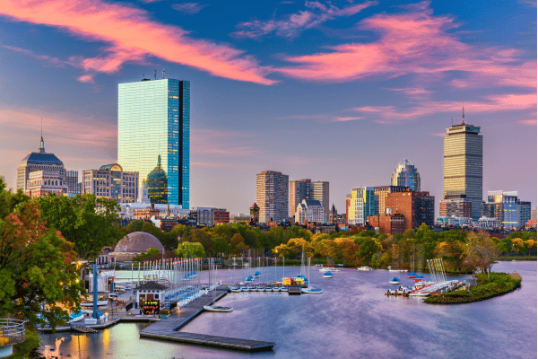 Boston skyline and waterfront at sunset, representing a target market for construction business development