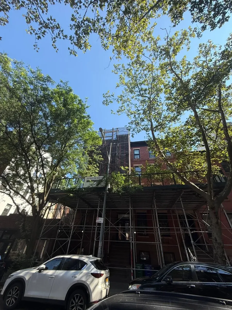 Dualcore Local Law 11 facade restoration at 668 President Street, Brooklyn, with pipe scaffold and sidewalk shed
